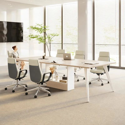 Small Affney meeting table in elm, the 6′7″ (79-inch) four-seat size, with a woman working at a laptop