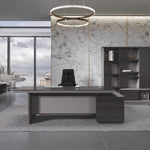 Allard executive desk, left return, beneath a ring chandelier in a marble executive office