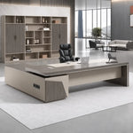 Walnut Altair L-shaped desk in a CEO office with lounge seating by the windows