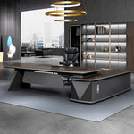 Alwin desk in walnut, left return, beside a silver display bookcase