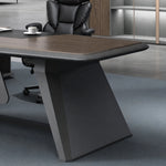Faceted charcoal blade leg of the Alwin desk on carpet