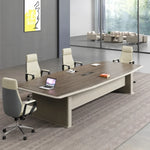Alwyn 8′ (96-inch) six-seat meeting table in walnut with an open laptop and three leather chairs
