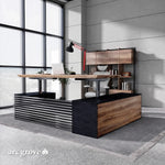 Anderson height adjustable executive desk raised for standing work in a brick-walled loft office