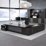 Atlas big executive desk in Midnight Black, left return, in a corner office with lake views