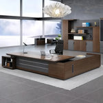 Dark Oak Atlas grand desk, left return configuration, in a CEO office with display cabinets