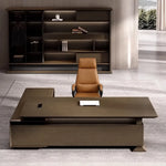 Atlee L-shaped desk facing a backlit bookcase wall, cognac leather chair behind