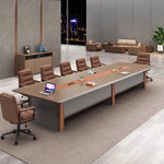 Brock 15′9″ (189-inch) large conference table seating 14, angled view with a laptop and cream chairs