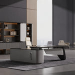 Caldrin desk, right return, in a gray gallery office with cream chair