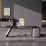 Caldrin desk with curved blade base in a spare concrete office