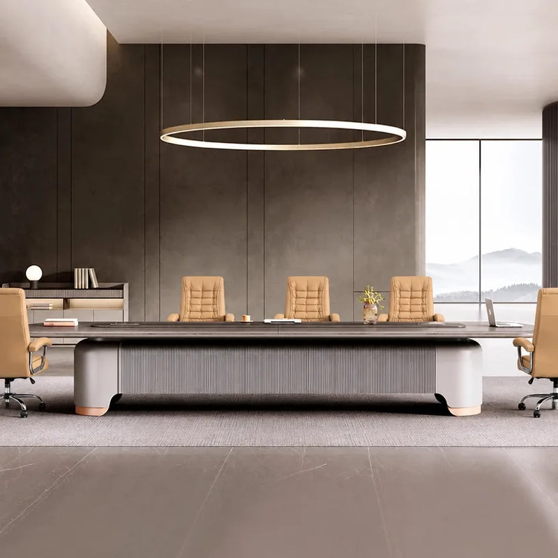 Caliber conference table with tan leather chairs beneath a ring pendant in a room with mountain views