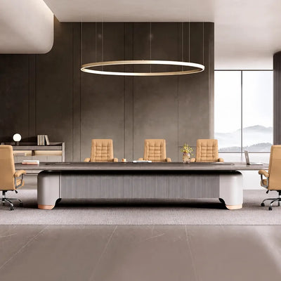 Caliber conference table with tan leather chairs beneath a ring pendant in a room with mountain views
