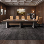 Callum large conference table seating 12 beneath ring pendant lights with a city skyline view