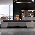 Canon executive desk in a black-paneled designer office