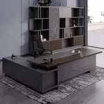 Carwin desk in dark walnut, right return, against a marble shelf wall