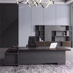 Carwin executive desk beneath a ribbon chandelier, staircase behind