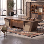 Cognac desk, right return, in a boss's corner office with dark shelving