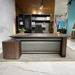 Photo of the Cole desk staged in a furniture showroom
