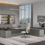 Elevon desk with side table arm in a glass-walled corner office
