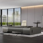 Elevon desk facing floor-to-ceiling windows with garden view