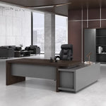 Elmore desk, left return, in a maroon-paneled corner office