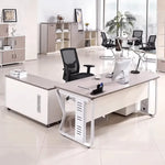Eszti manager desk with base return in a bright open office