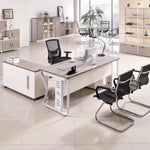 Eszti desk in light gray oak with guest chairs in an open workspace