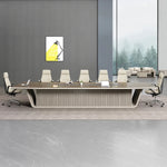 Evren walnut boardroom table with white leather chairs in a gray room with tall windows