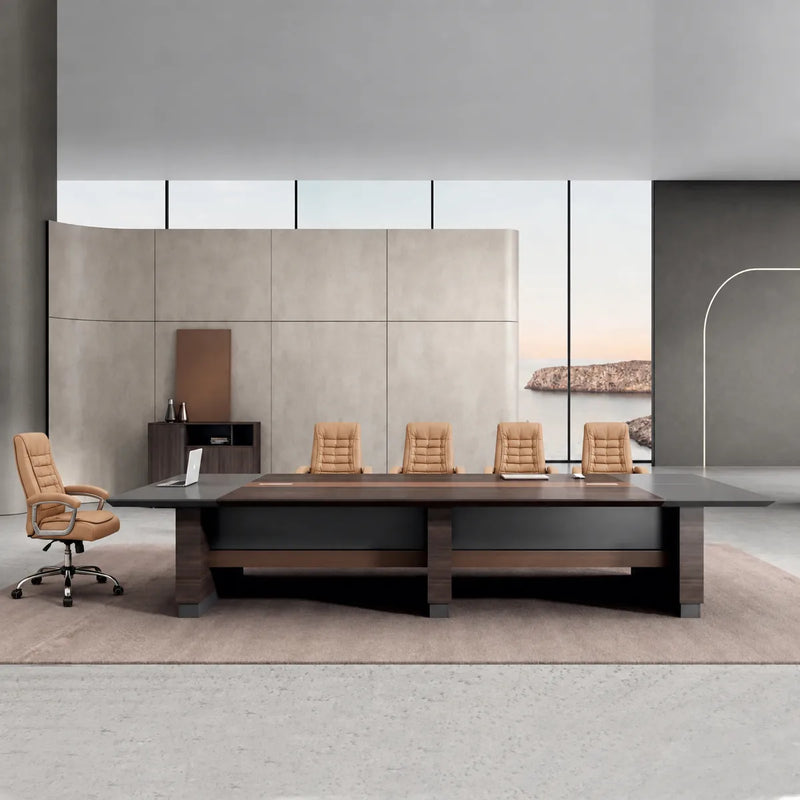 Fuller executive boardroom table in walnut with tan leather chairs against a stone wall and coastal window