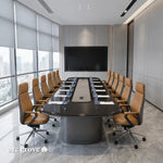 Fusion large conference table in ebony set for a meeting with white chairs, facing a wall display