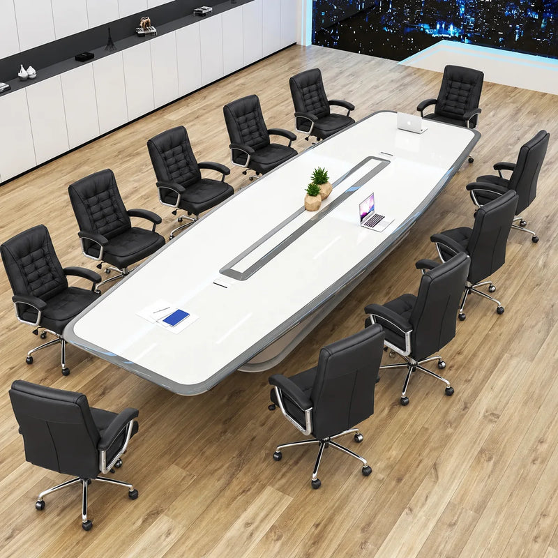 Angled overhead view of the Harmony large conference table with 12 black-and-white chairs and a city night view
