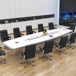 Harmony white high-gloss conference table with a laptop and plant, black leather chairs, three-quarter view