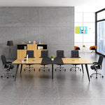 Harvard elm conference room table with black chairs against a concrete wall with city windows