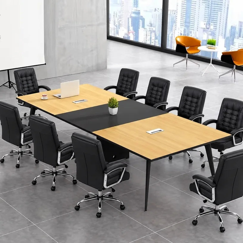 Harvard elm meeting table with eight black mesh chairs and a laptop, angled view by the window
