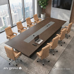 Angled overhead view of the Hunter conference table with ten tan chairs, laptop and remote on the gray runner