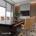 Hunter conference table close up showing the LED lighting strip beneath the top edge and a laptop