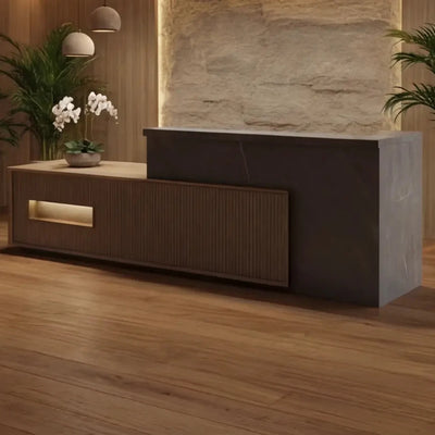 Knox front desk against a stone feature wall in a hotel lobby