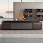Kaius desk in walnut in a seaside office with shelf wall