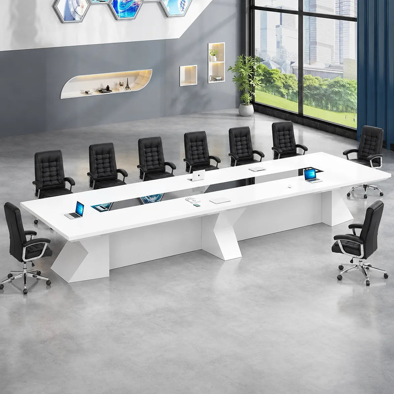 Kendrix white boardroom table seating 12 in orange chairs in a loft office with hexagonal wall screens
