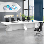 Kendrix white conference table with orange chairs, tablets on the center channel, tall windows and blue drapes
