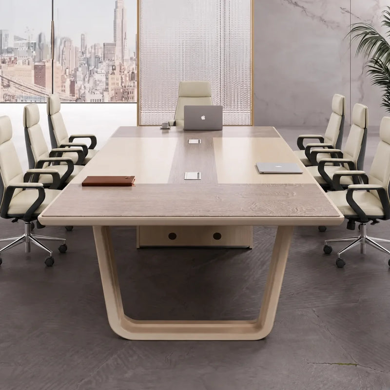Lyric conference table with a laptop and tan leather chairs, viewed from the head of the table