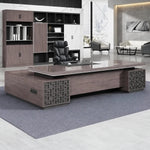 Magnus desk in a white-marble CEO office with lounge chairs