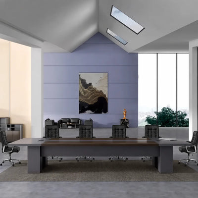 Maxum massive boardroom table in walnut with black chairs in a vaulted room with skylights