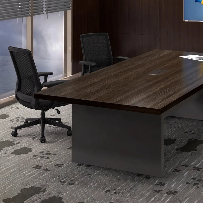 Maxum conference table end view with a black leather chair by a window with blinds
