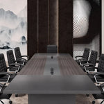 Medley conference table with black leather chairs viewed from the head, pop-up charging modules on the runner