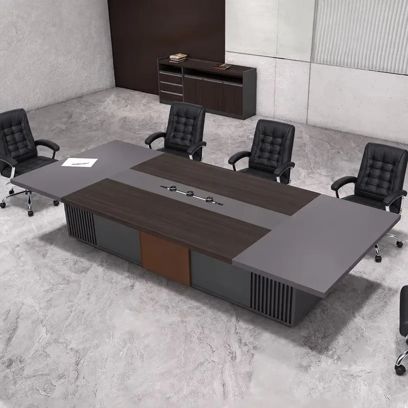 Medley 12′ (144-inch) conference table seating 12 in black chairs on a stone floor, angled overhead view