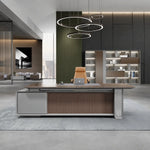 Myer grand desk under ring chandeliers with display wall