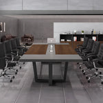 Oakburn professional conference table seating 12 in black leather chairs with storage cabinets behind