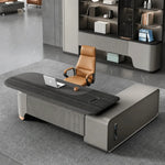 Ordin desk from above with cognac chair and laptop