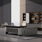 Orvane desk with fluted pedestal in a stone-wall office
