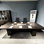 Prime brown conference table set with notepads and leather chairs, photographed in a client office
